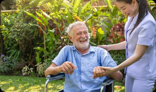 Memory Care Costs in Southern California - Senior man smiling with caregiver outdoors